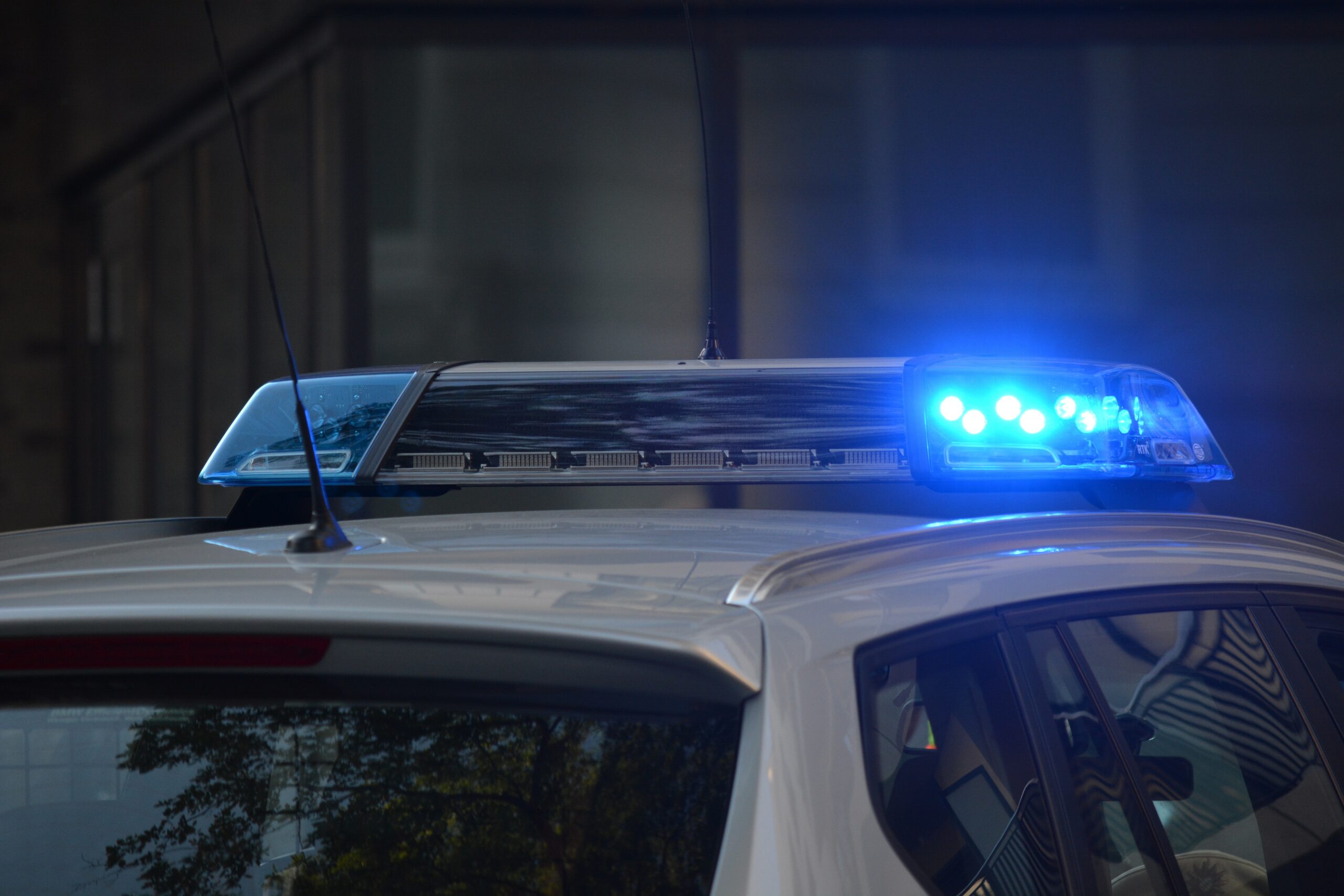 The top of a police car with it's blue light flashing