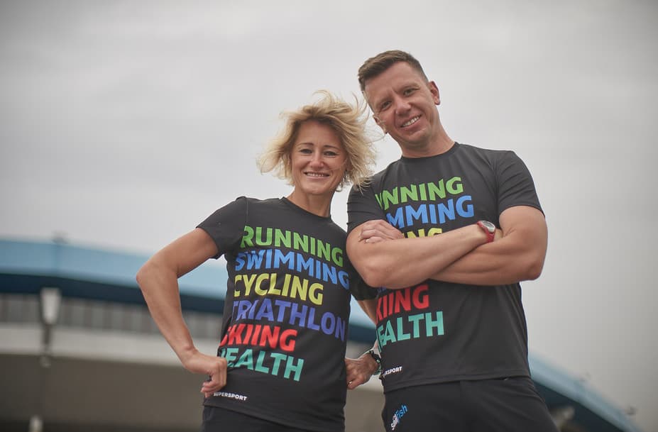 Two people wearing sports t-shirts and smiling