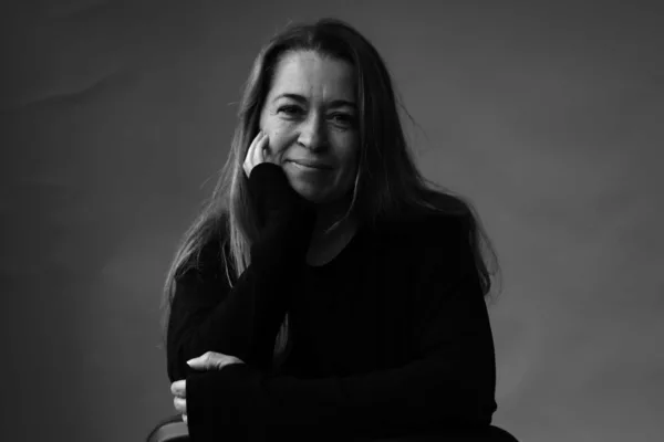 Woman with long hair sitting on chair