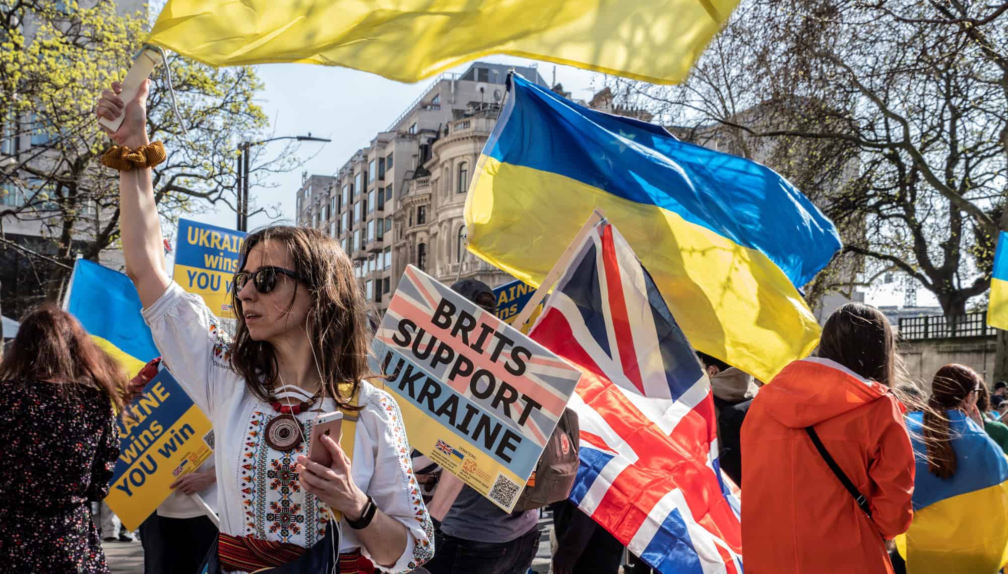 A woman waving a Ukrainian flag