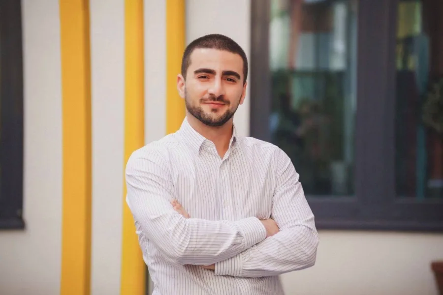Man in white shirt with arms crossed