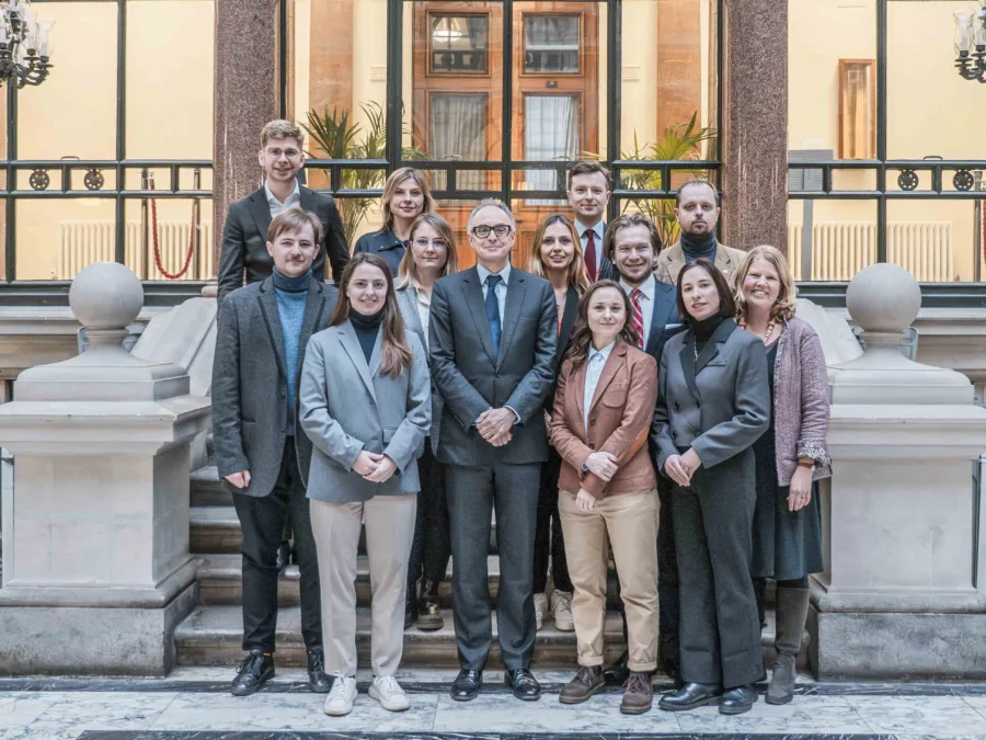 A group of young men and women standing on steps at the FCDO