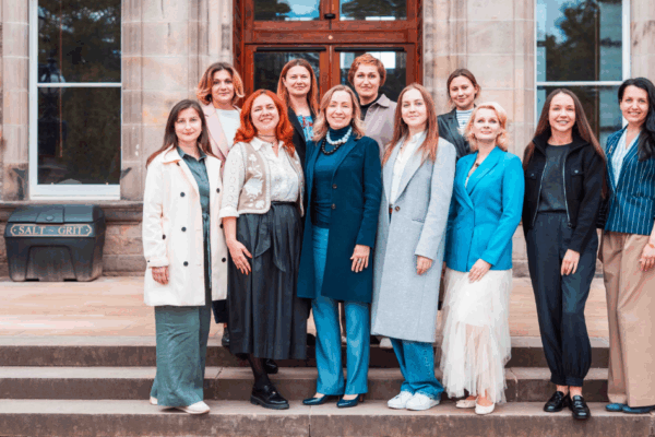12 women / John Smith Fellows on steps in front of the Edinburgh Business School
